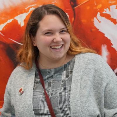 Caroline Calloway smiling red background
